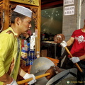 Pounding peanuts into a paste