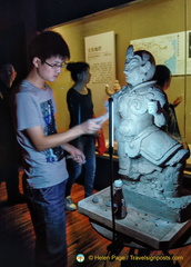Young sculptor replicating the Heavenly God statue