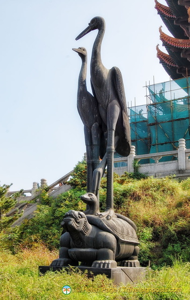 Two celestial cranes standing on a snake and turtle