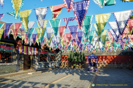 Colourful flags in this courtyard