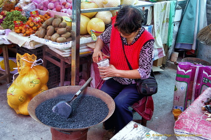A Stallholder at the Sandouping Village Market