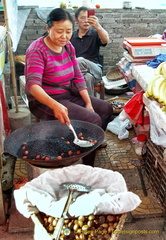 A Chestnut Vendor at the Sandouping Village Market